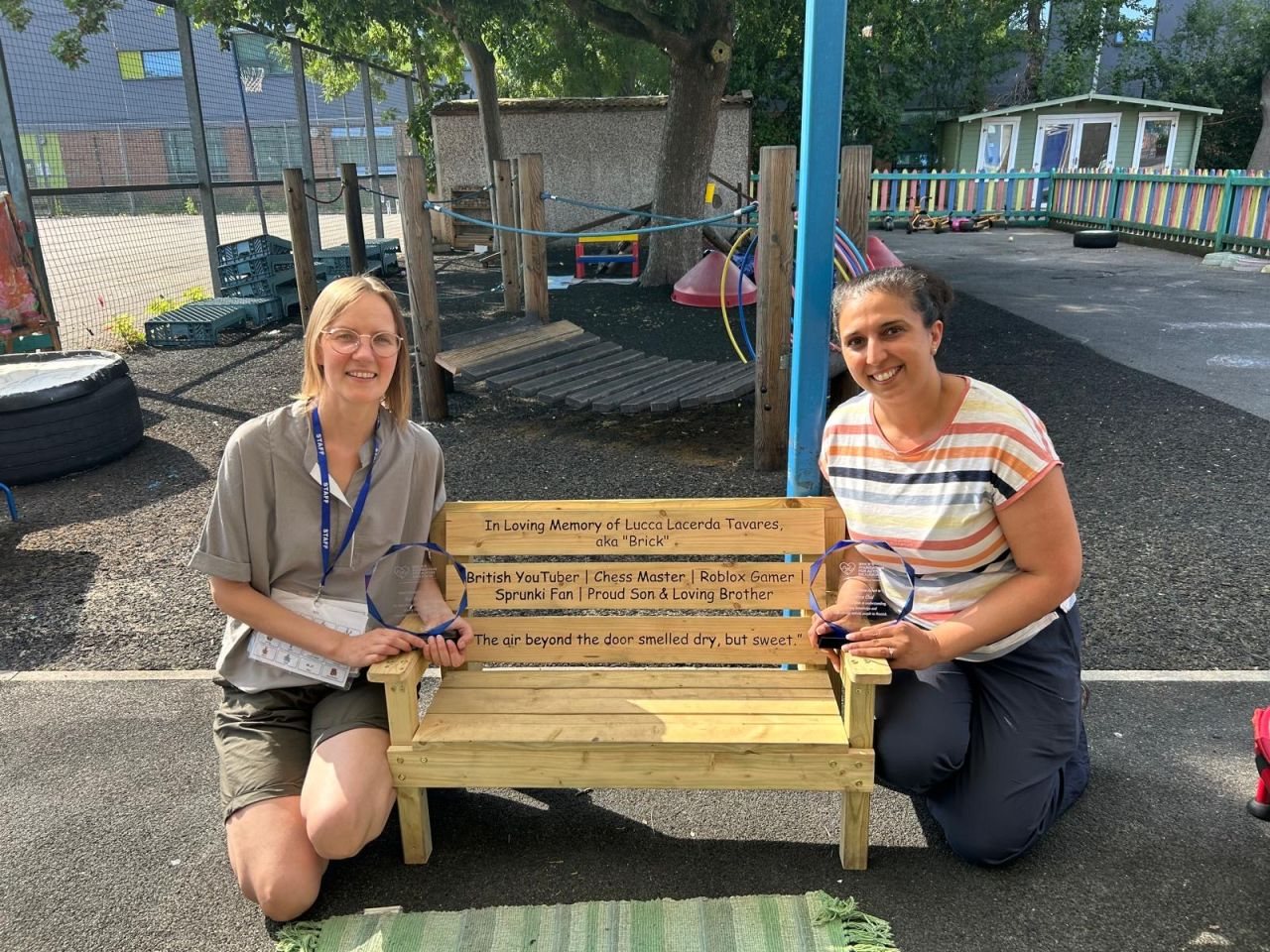 Ilga Mezatuca and Sandeep Chal with their awards, beside the Friendship Bench