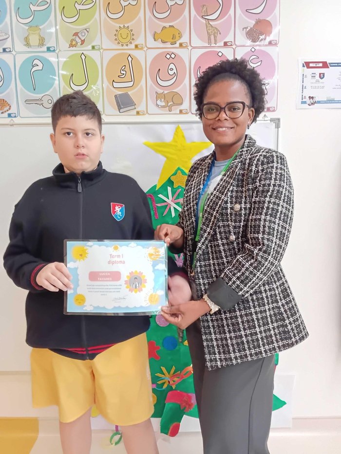 Lucca proudly holding his Term 1 diploma with Mrs Mukovhe Makhwedzha