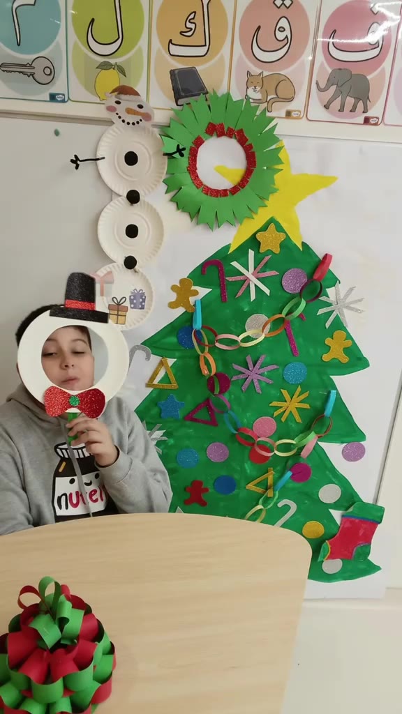 Video: Lucca in a snowman mask with his paper Christmas tree