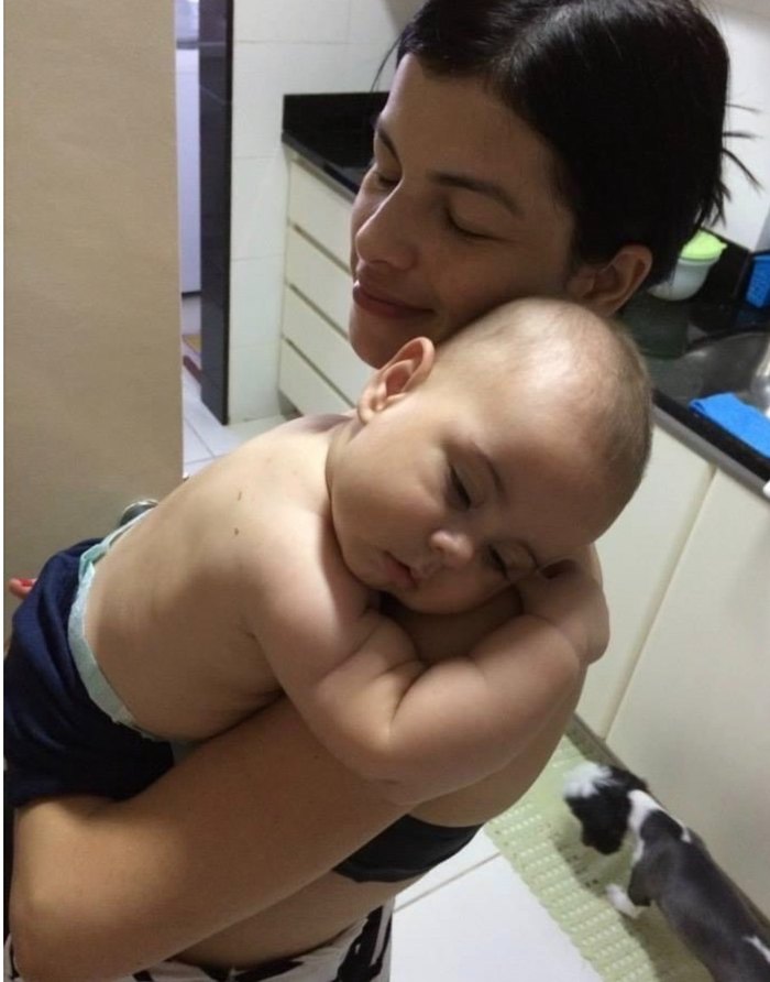 Baby Lucca asleep on his mum's shoulder
