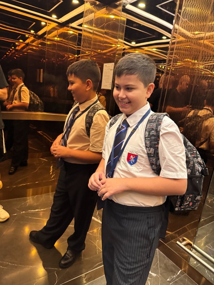 Lucca smiling in his school uniform and backpack