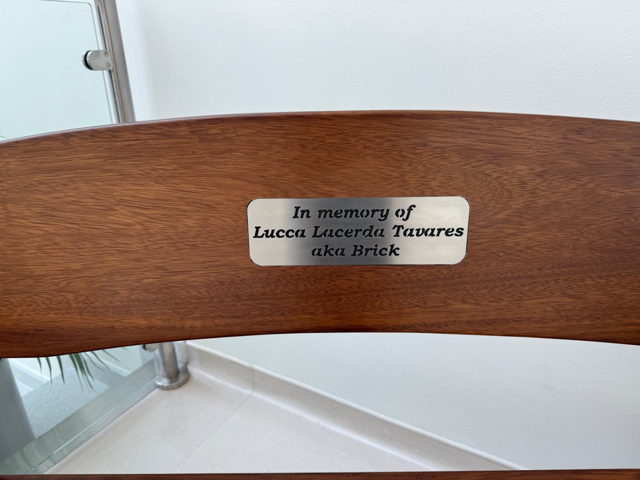 Close-up of the plaque: In memory of Lucca Lacerda Tavares aka Brick